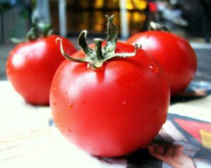 Three homegrown tomatoes on a table