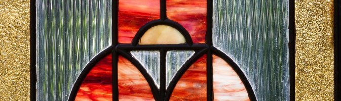 A photo of a stained glass front door window in the art nouveau style
